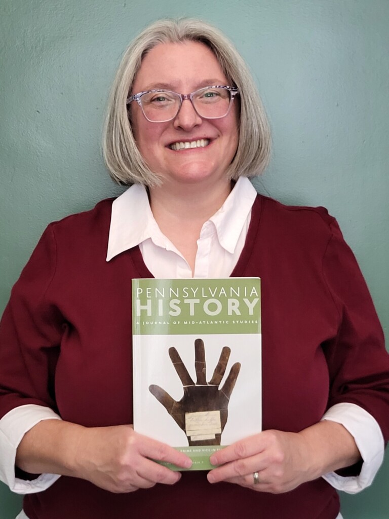 Image of the guest editor holding a copy of the special issue.